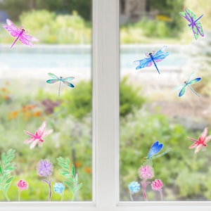 May include: A set of colourful dragonfly window clings. The clings feature a variety of dragonfly designs in shades of blue, green, pink, and purple. The clings are perfect for adding a touch of whimsy to any window.