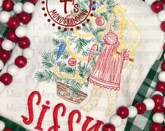 May include: Embroidered design of a girl holding a Christmas tree with ornaments and the text "Miss T's Monogramming" and "Sissy" in red.
