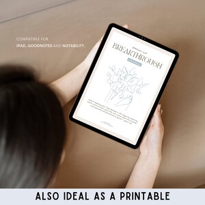 May include: A digital tablet displaying a break-up journal with a line drawing of butterflies and hands. The text on the screen reads "Break-Up Breakthrough Journal".