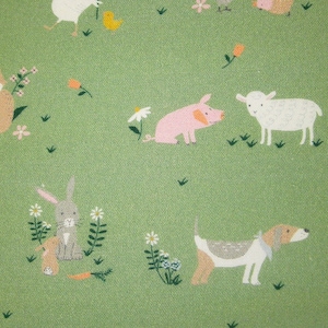 May include: A green fabric with a repeating pattern of farm animals, including a cat, pig, rabbit, sheep, and dog. The animals are illustrated in a simple, cartoon style.