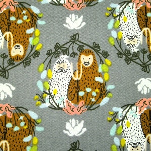 May include: Grey fabric featuring a repeating pattern of cartoon-style figures. The figures are brown and white, encircled by floral wreaths with pink, yellow, and blue accents. White flower shapes are scattered across the background.