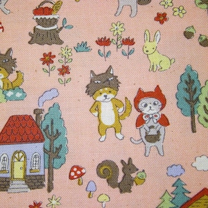 May include: A pink fabric with a repeating pattern of woodland animals, houses, and trees. The animals include a wolf, a fox, a squirrel, a rabbit, and a cat. The houses are small and have red roofs. The trees are green and have brown trunks.