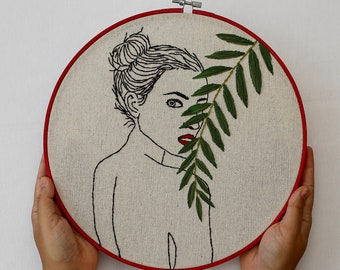 Hand embroidery hoop art with woman and plants