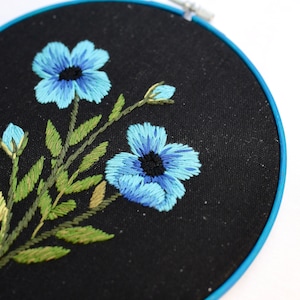 Hand embroidery hoop art with blue flowers