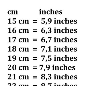 May include: A conversion chart showing the equivalent measurements in inches for centimeters from 15 cm to 23 cm. The chart is written in black text on a white background.