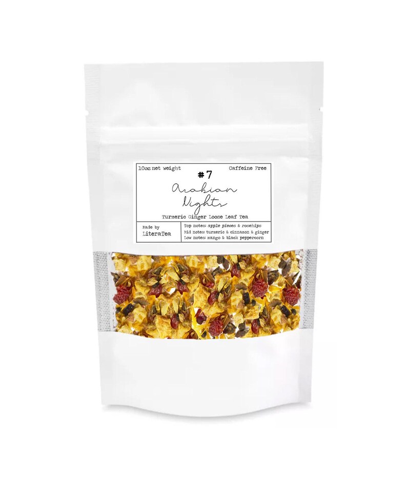 May include: A white pouch of loose leaf tea with a clear window displaying the tea blend. The label reads "#7 Arabian Nights Turmeric Ginger Loose Leaf Tea." The tea blend includes apple pieces, rosehips, turmeric, ginger, mango, and black peppercorn. The pouch is caffeine-free.