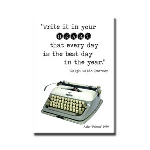 May include: A vintage typewriter with the quote "Write it in your HEART that every day is the best day in the year." by Ralph Waldo Emerson. The typewriter is a gray Adler 'Primus' model from 1959.