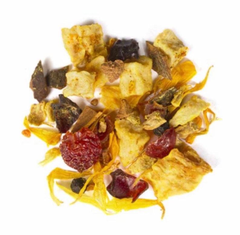 May include: A close-up of a pile of dried tea leaves and fruit pieces. The mix includes yellow, red, and brown pieces, with some yellow flower petals. The tea appears to be a blend of fruits and herbs.
