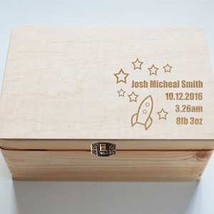 May include: A wooden keepsake box with a laser engraved design of a rocket ship and stars. The box is personalised with the name "Josh Micheal Smith", the date "10.12.2016", the time "3:26am", and the weight "8lb 3oz".
