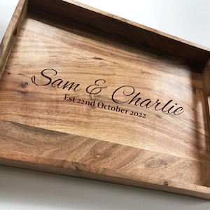 May include: A wooden serving tray with a personalised inscription that reads "Sam & Charlie Est 22nd October 2022".