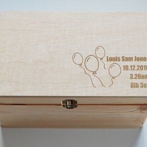 May include: A wooden keepsake box with a hinged lid and a brass latch. The lid is engraved with a drawing of balloons and the text "Louis Sam Jones 10.12.2016 3.26am 8lb 3oz".