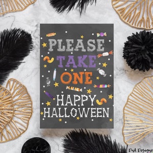 May include: A black chalkboard sign with white stars and colorful candy graphics. The sign reads "Please Take One Happy Halloween".