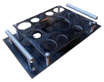 May include: A black metal drink holder with a clear plastic insert. The holder has eight round holes for glasses and two silver handles.