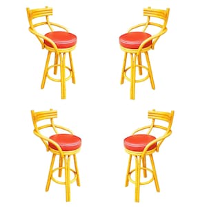May include: Four bamboo bar stools with red vinyl seats. The stools have a curved backrest and footrest. The bamboo is a light yellow color.