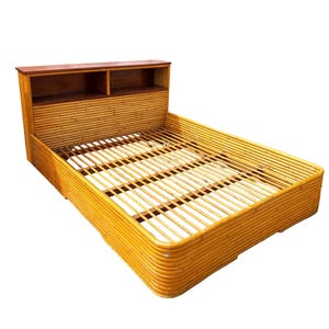 May include: A light brown bamboo bed frame with a headboard featuring two open shelves. The bed frame has a slatted base and a rounded design. The headboard is made of a darker wood.