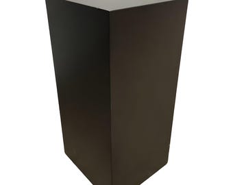 May include: A black square pedestal, a simple and modern design, perfect for displaying items or as a decorative accent.