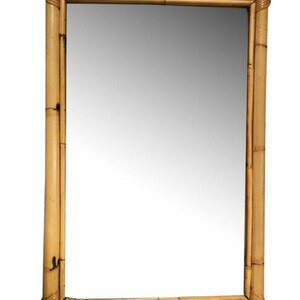 May include: A rectangular mirror with a natural bamboo frame. The frame is made of woven bamboo strips and has a slightly rounded edge. The mirror is reflecting a white background.