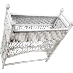 May include: White wicker plant stand with a woven design and a curved base. The stand has a white painted finish and a removable shelf.