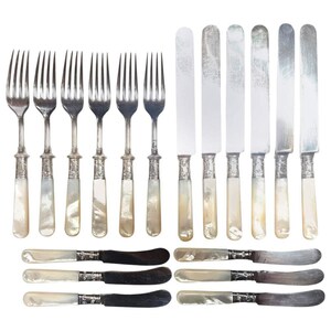 May include: Set of silver flatware with mother-of-pearl handles. The set includes forks and butter knives.