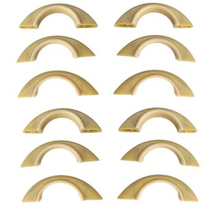 May include: Twelve identical beige, semi-circular plastic components arranged in two vertical columns of six. Each piece features a curved outer edge and a flat inner base with visible hollow structural channels along the bottom surface.