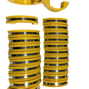 May include: A collection of curved, yellow plastic segments with metallic silver bands along the center. The pieces are stacked in two vertical columns, with one individual segment shown open at the top to reveal internal hinges and screw holes.