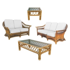 May include: A wicker furniture set with two sofas and a coffee table. The sofas have white cushions and the coffee table has a glass top.