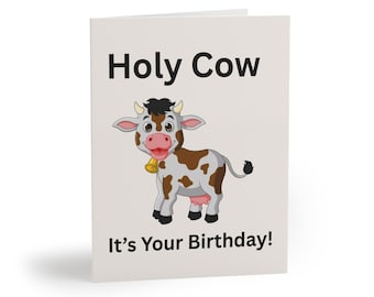 May include: A birthday greeting card with the text "Holy Cow" above a cartoon cow illustration. The cow is white with brown spots, a pink nose, and a gold bell. The text "It's Your Birthday!" is below the illustration.