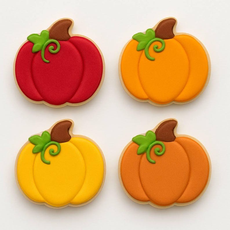 May include: Four pumpkin-shaped cookies with a light-colored border. Each cookie has a different color: red, orange, yellow, and a darker orange. Each pumpkin has a brown stem and green vine detail.