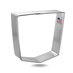 May include: A silver metal cookie cutter shaped like a square with a rounded bottom edge. The cookie cutter is made in the USA.