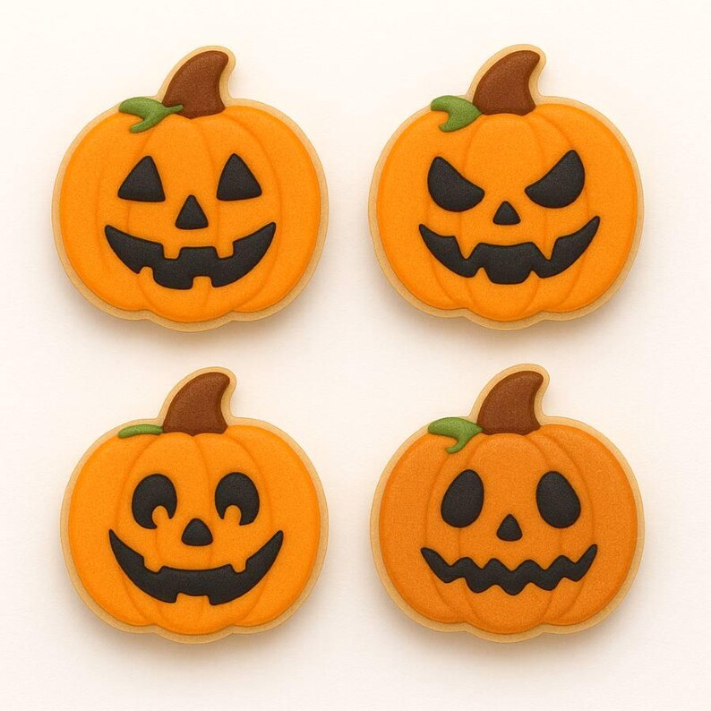 May include: Four Halloween-themed sugar cookies shaped like jack-o'-lanterns. Each cookie has an orange pumpkin with a brown stem and green leaf. The jack-o'-lantern faces are cut out with black icing. The cookies are on a white background.