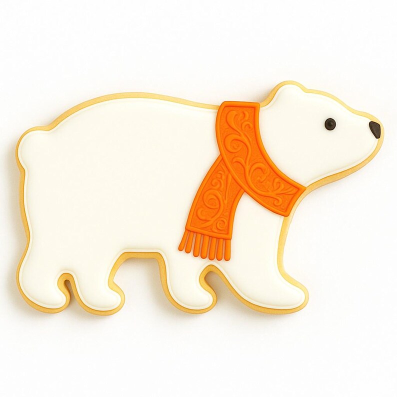 May include: A polar bear cookie with white icing and an orange scarf. The cookie has a yellow outline and black eyes. The scarf has a detailed design. The bear is walking on a white surface.
