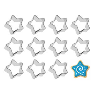 May include: A collection of star-shaped cookie cutters made of shiny, silver metal. One star-shaped cookie is decorated with blue icing and a white swirl design. The cookie cutters are arranged on a white background.