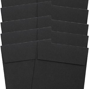 May include: A stack of black square envelopes with a flap closure. The envelopes are made of a matte paper material and are arranged in a slightly overlapping pattern. The image is well-lit, showing the texture and shape of the envelopes.