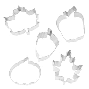 May include: Five metal cookie cutters in the shapes of a pumpkin, apple, acorn, and two different leaves.
