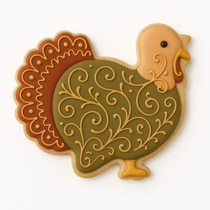 Puede incluir: Una galleta decorada con forma de pavo con un dise&ntilde;o detallado. La galleta presenta una cola marr&oacute;n, un cuerpo verde con remolinos dorados y una cabeza beige con un ojo negro. Un dulce festivo.