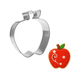May include: A stainless steel apple-shaped cookie cutter next to a decorated apple cookie. The cookie is red with white floral accents and a brown stem and green leaf. The cookie cutter is a simple outline of an apple.