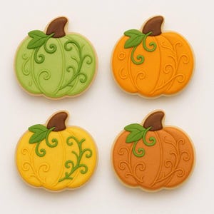 May include: Four pumpkin-shaped cookies with intricate designs. Each cookie features a different color: green, orange, yellow, and brown. The cookies have brown stems and green leaves, with a decorative swirl pattern.