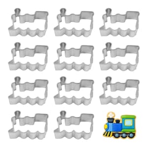 May include: A collection of silver-colored train-shaped cookie cutters. The cutters are arranged in a grid pattern, with one colorful, finished cookie in the lower right corner. The finished cookie is blue, green, yellow, and black.