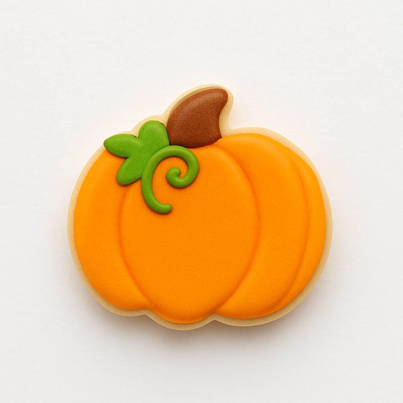May include: A pumpkin-shaped cookie with orange icing, a brown stem, and a green vine. The cookie has a light-colored border and is a festive treat for fall or Halloween.