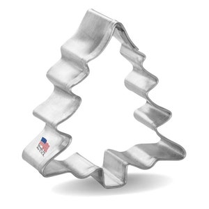 May include: Silver metal Christmas tree cookie cutter. The cutter has a wavy, scalloped edge. The cutter is made in the USA.