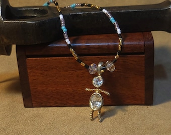 Item #12-37 -Beaded Necklace - Crystal Girl on a Turquoise Black, White and Gold Strand