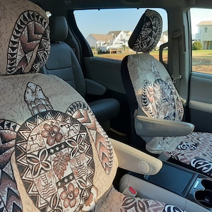 May include: Two car seat covers with a beige background and a brown turtle design. The turtle design features a floral pattern and geometric shapes.