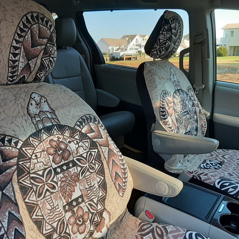 May include: Two car seat covers with a beige background and a brown turtle design. The turtle design features a floral pattern and geometric shapes.