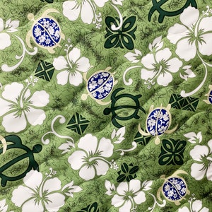 May include: Green fabric with a repeating pattern of white hibiscus flowers, green turtles with blue shells, and green stylized floral designs.