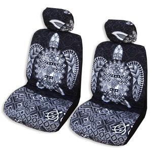 May include: Two black and white car seat covers with a Hawaiian turtle design. The covers feature a large turtle with intricate patterns and a black and white geometric design on the bottom.