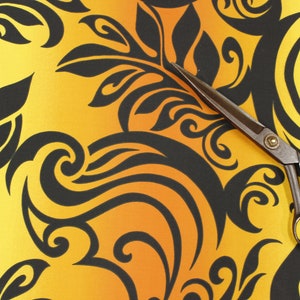 May include: A pair of black fabric scissors with a yellow and orange gradient background featuring a black floral pattern.