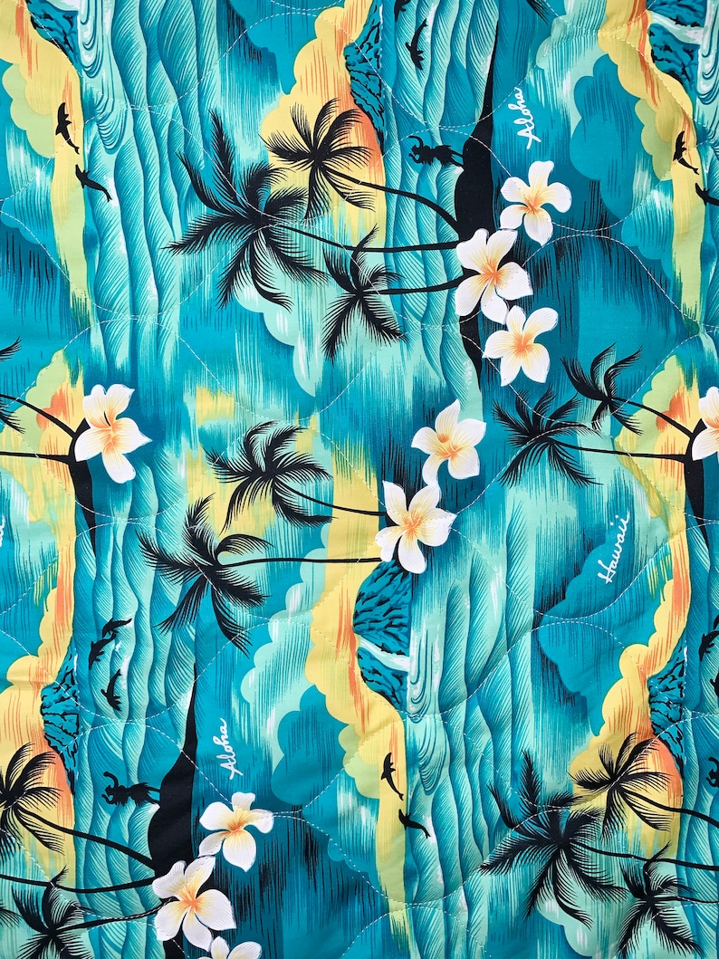 May include: A turquoise blue fabric with a repeating pattern of palm trees, waves, and flowers. The fabric has the words "Aloha" and "Hawaii" printed on it.
