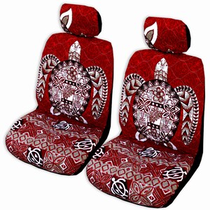 May include: Two red car seat covers with a white turtle design. The turtle has a Polynesian pattern and is surrounded by a white border. The seat covers have a red and white geometric pattern.