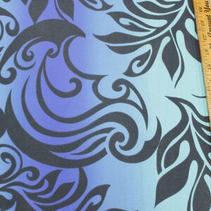May include: Blue and black fabric with a gradient pattern of swirling designs. The fabric has a repeating pattern of stylized leaves and waves. The fabric is measured with a ruler that says "Measure Your Success By The Amount You ..."
