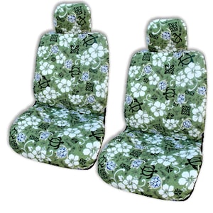May include: Two green car seat covers with a white hibiscus and sea turtle pattern.